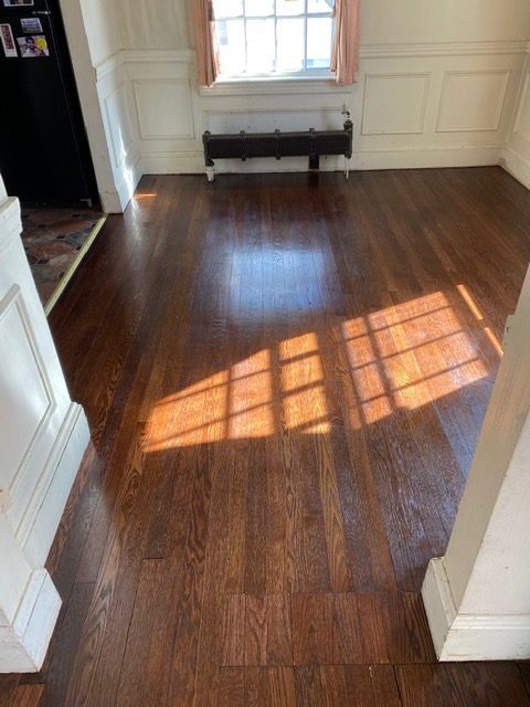 
<p>Client in Belmont with old, high trafficked floors needed a refinish, but I suggested doing a darker stain to “hide” the badly damaged water worn areas that I figured would still look “cloudy”.  They agreed and the results speak for themselves!</p>
<!-- /wp:paragraph -->